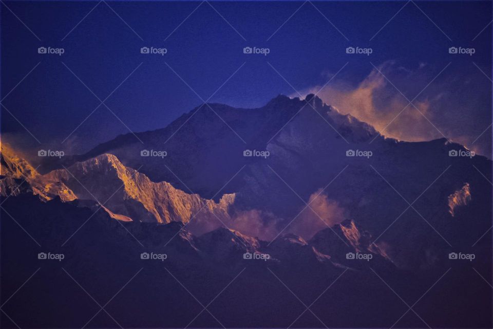The Kanchenjunga mountains spotted from a drive through a road of adjacent mountains. Majestic.