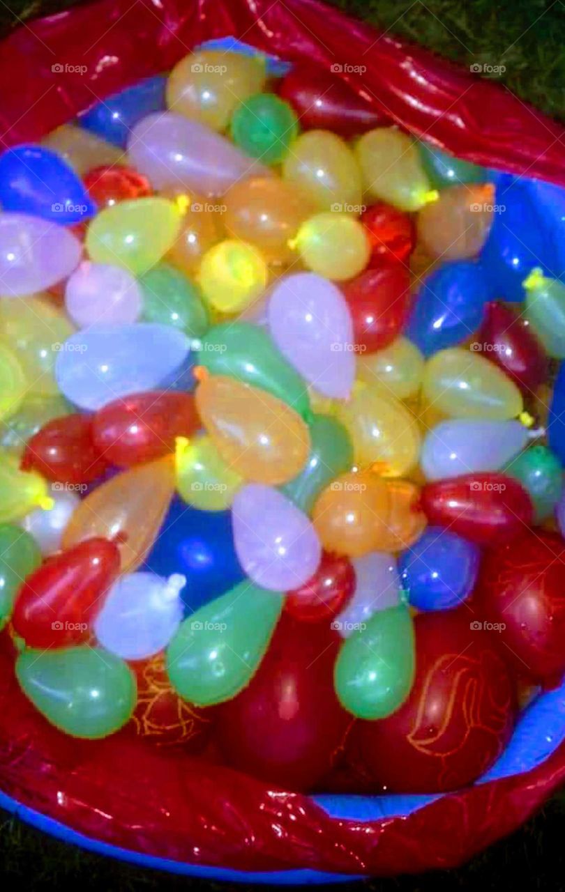 Pool full of water balloons ready for a water balloon fight .