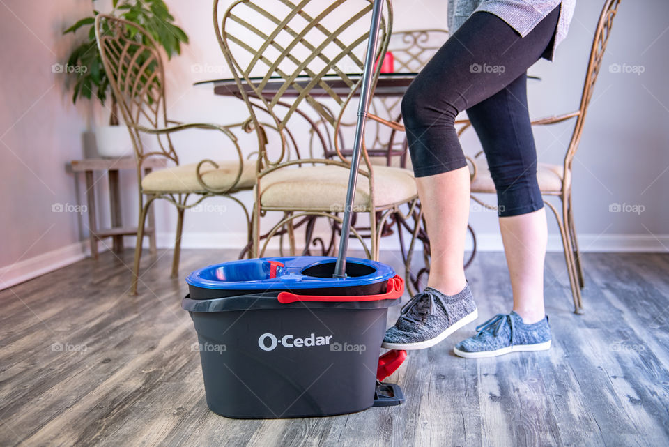 Woman using an O-Cedar mop and bucket 