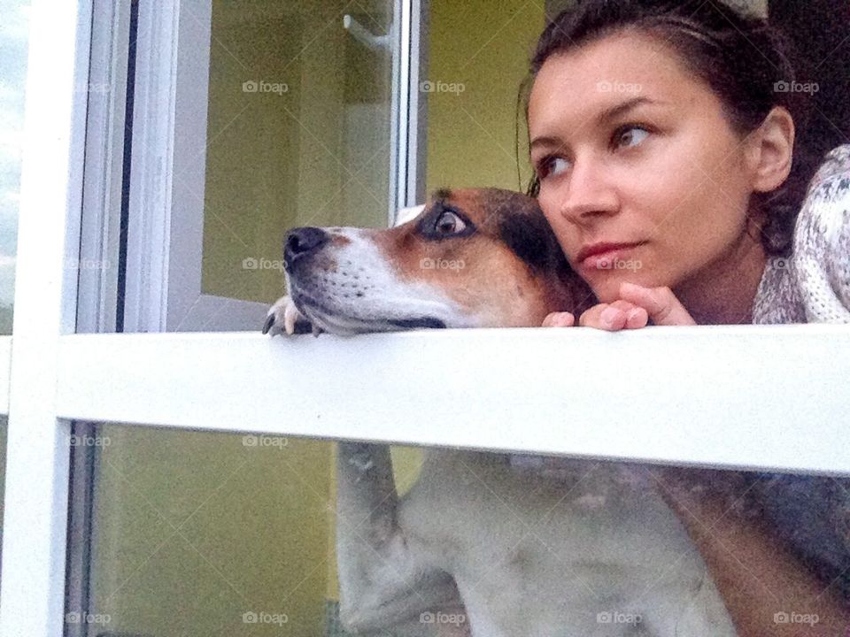 Girl with cute doggy in the window. 