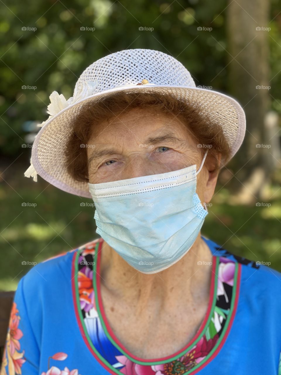 Senior lady with hygienic facial mask

