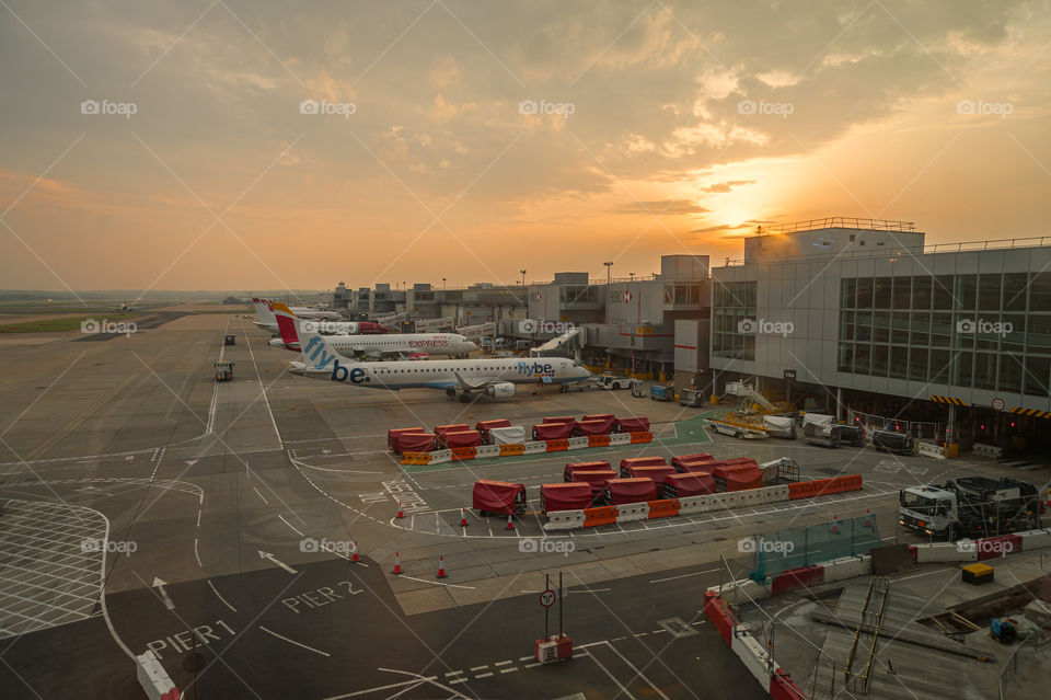 Airplanes at airport terminal.