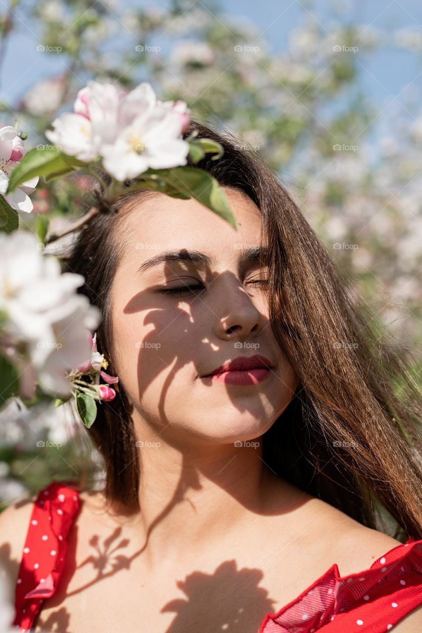 beautiful woman in spring blossom trees