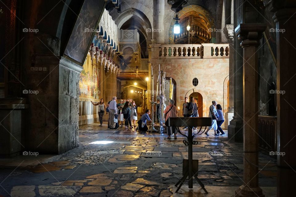 people praying in the holy sepulchre church in Jerusalem of Israel