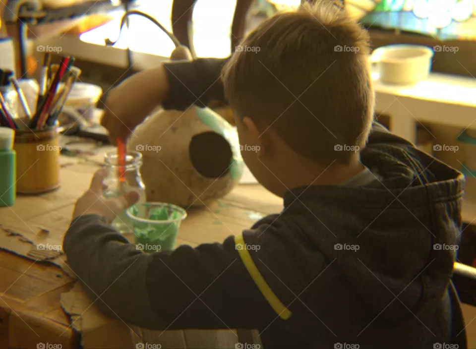 Young Boy Painting Birdhouse Gourd Craft Time