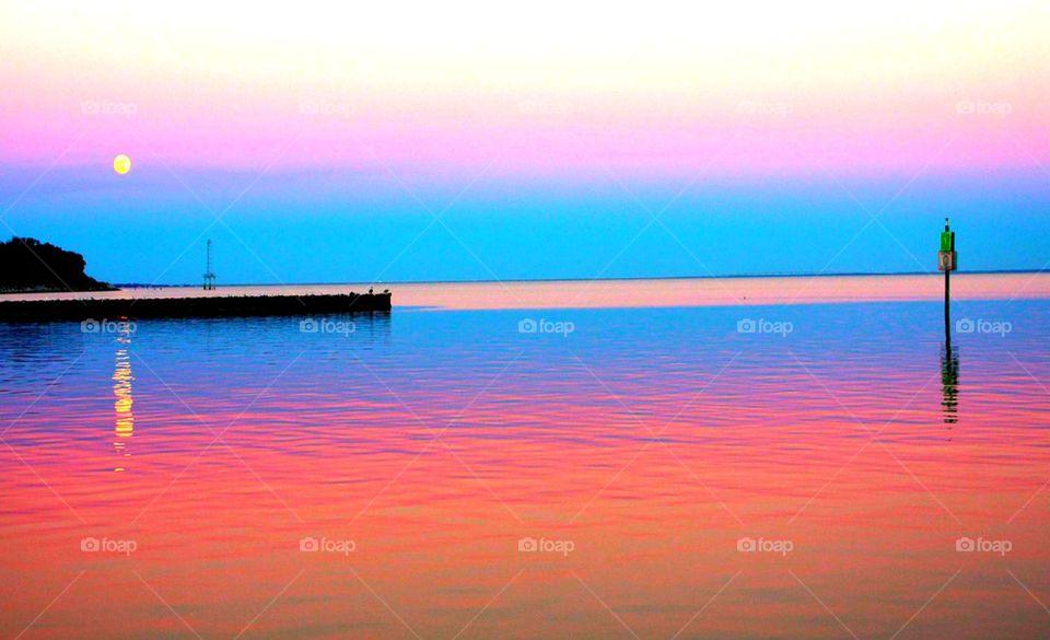 Idyllic view of sea and wooden post