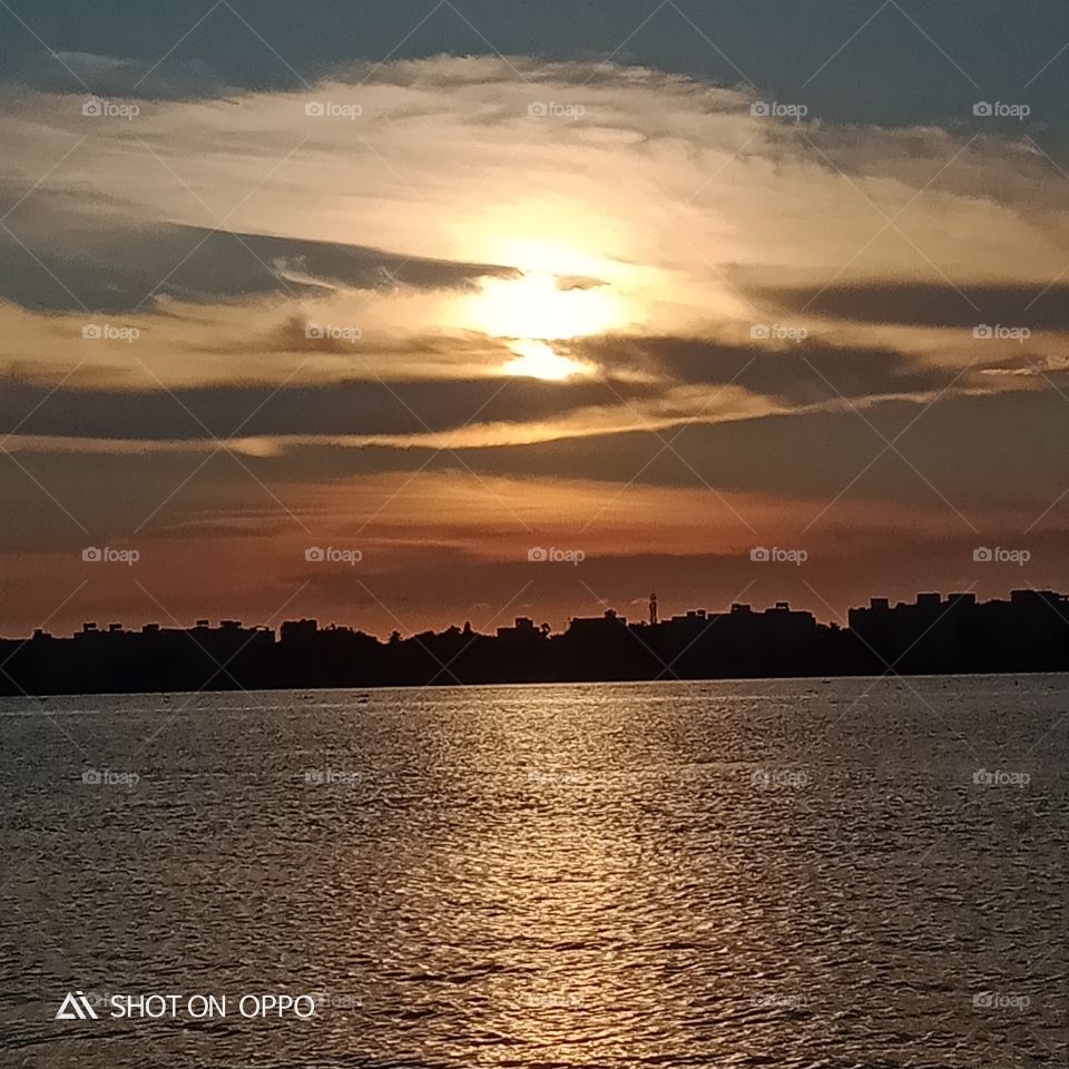 Sunset in the sky and water reflection