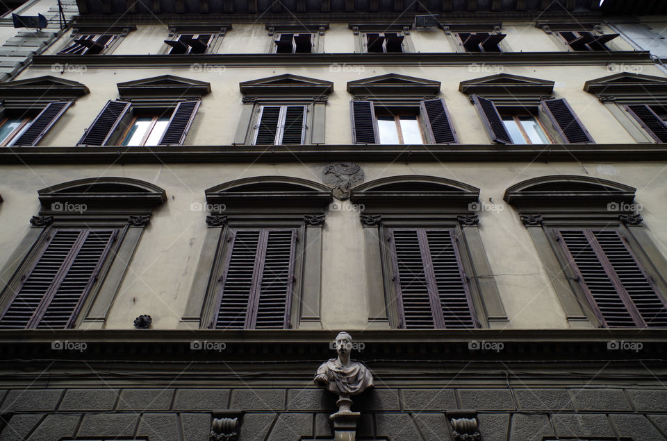 Low angle view of the exterior of a residential building in Florence, Italy.