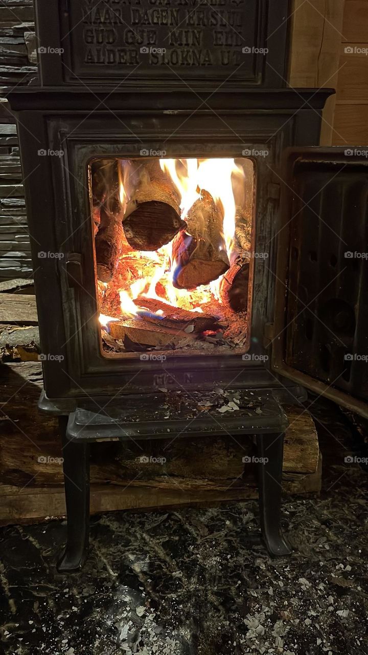 logs in a fireplace. cast iron black