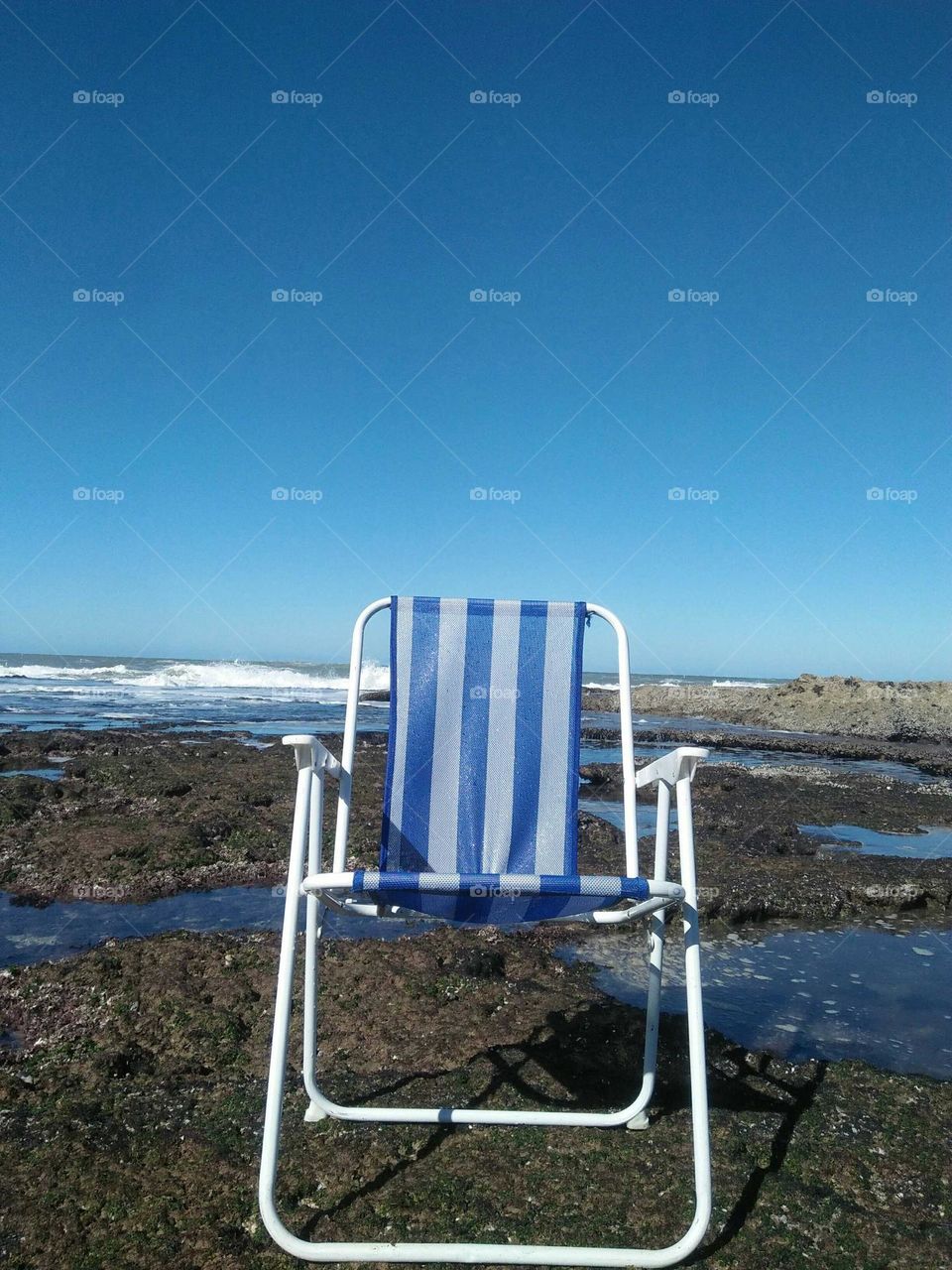 Beautiful blue chair near the sea at essaouira in Morocco.