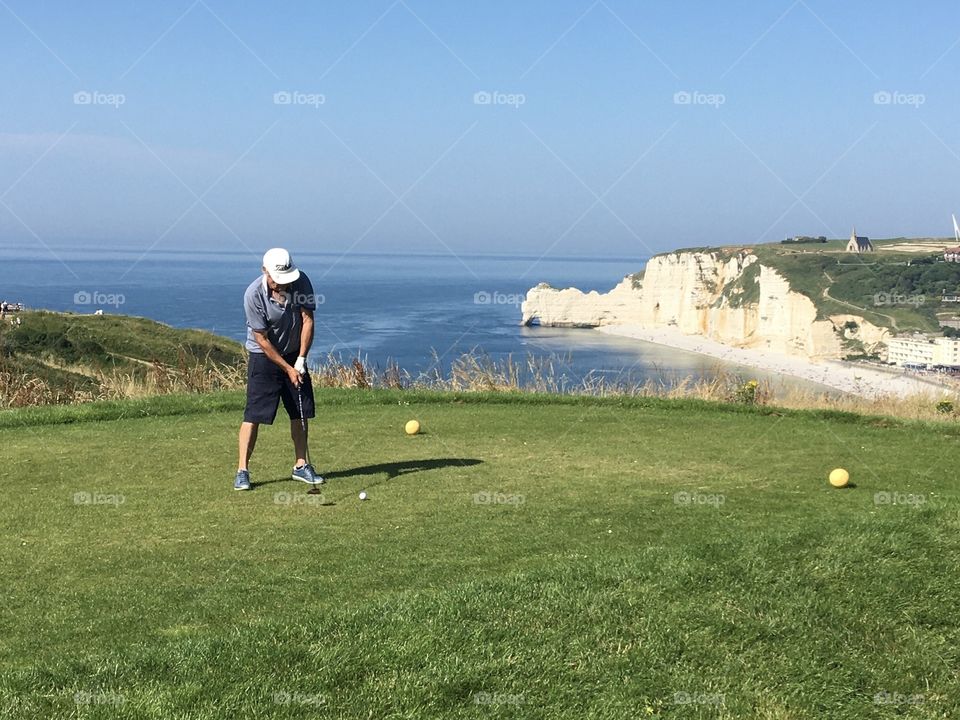 Playing golf in magical outside and seascape 