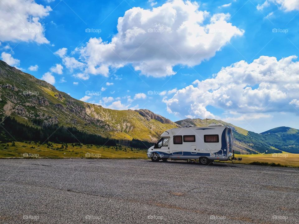 camper parked at the foot of the mountain, ready for the trip