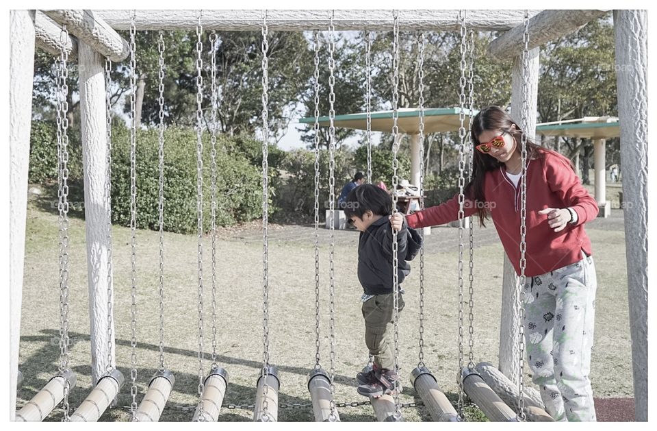 Japanese kid on obstacles playground