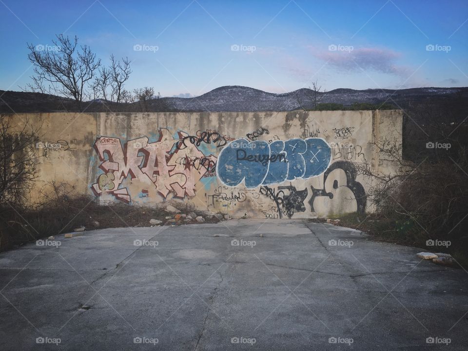 I love graffiti. Something about the cartoonish nature of it, on the rough and industrial concrete canvas, set against the wild expanse of nature. 
