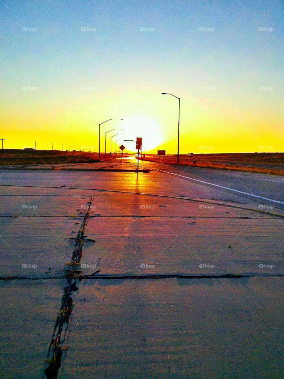 Sunrise at a truck stop. the pavement reflected the sky so well that morning.