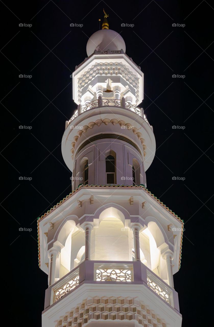 white mosque tower at night