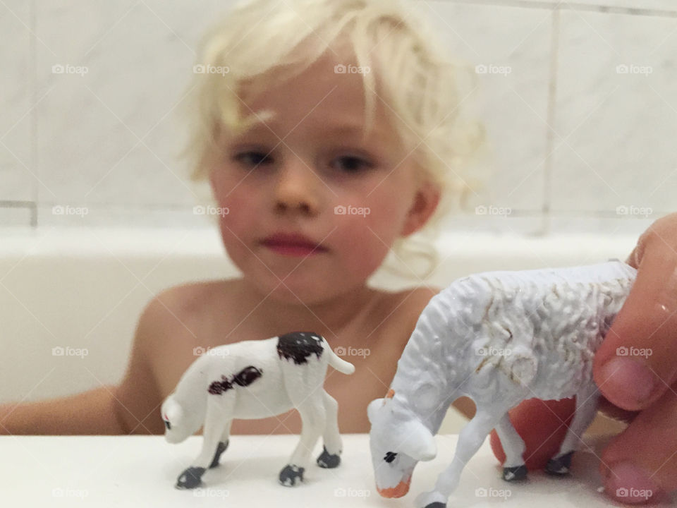 Boy playing on the bath