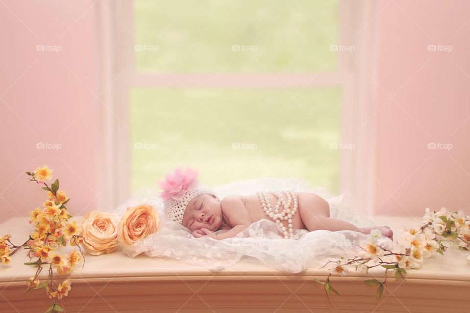 Baby kid sleeping on bed with rose flowers