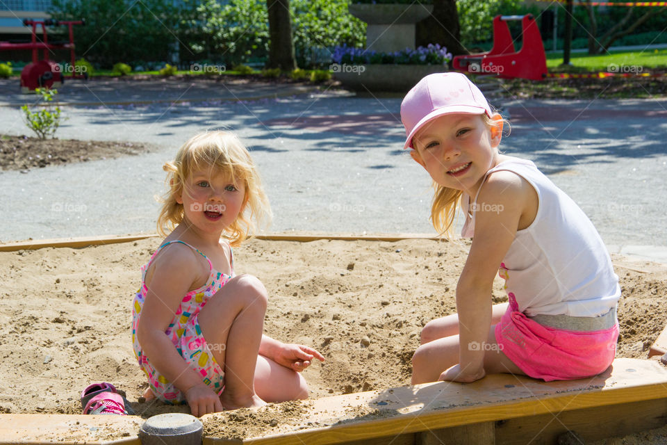 Two young sisters are playing in a playground in Malmö Sweden.