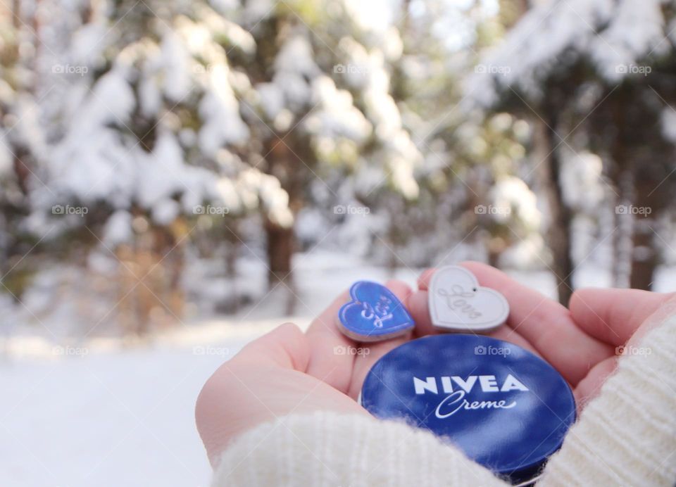 nivea cream in the hands in winter