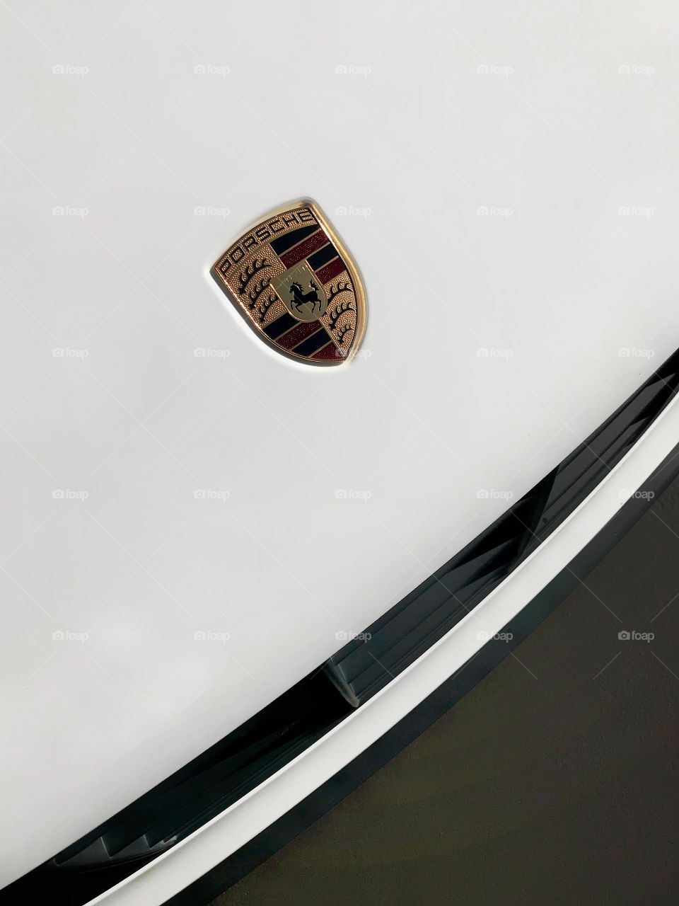 Crisp clean lines of a Porsche automobile are highlighted by the sun