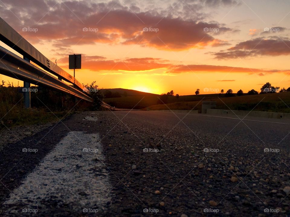 Empty road in the mountains at golden hour time
