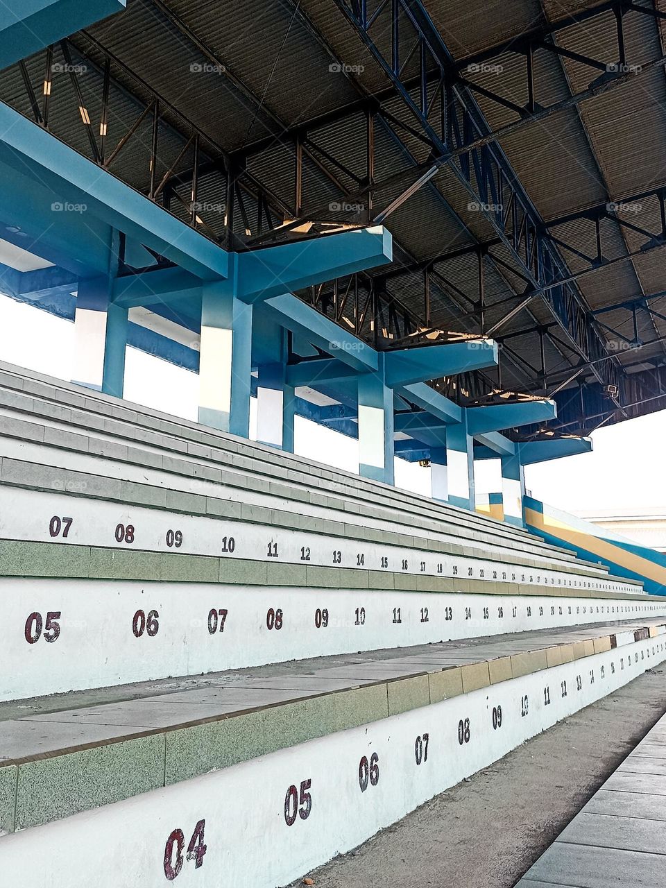 Part of a stadium with empty seats numbered