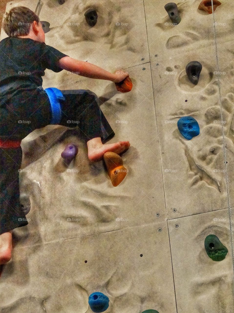 Boy Climbing Rock Wall