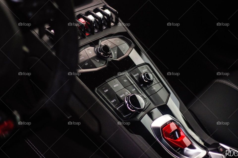 Black Lamborghini Huracan spyder with a vdm cars wrap central console with all of the radio controls, driving modes, heater controls, start stop button and a lot of other controls