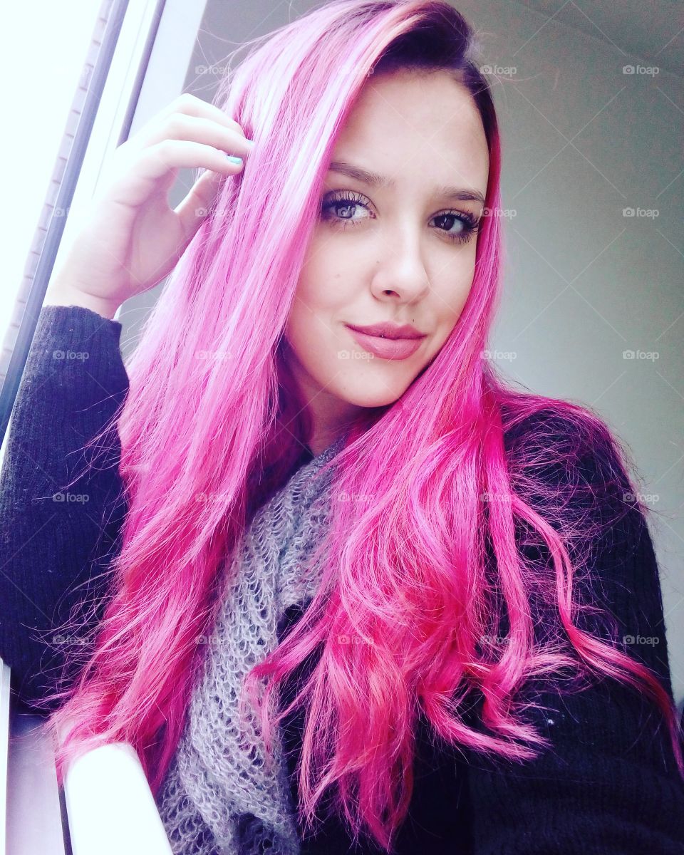 Beautiful woman with pink hair color