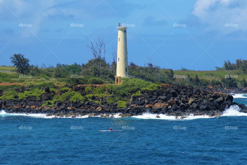 A lone lighthouse on a rock outcropping in Alaska's inland passage
