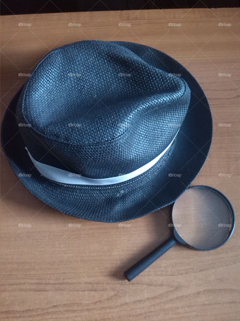Black hat and magnifying glass