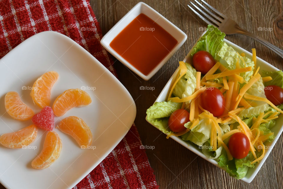 Crisp salad with cheese and a plate of mandarin oranges