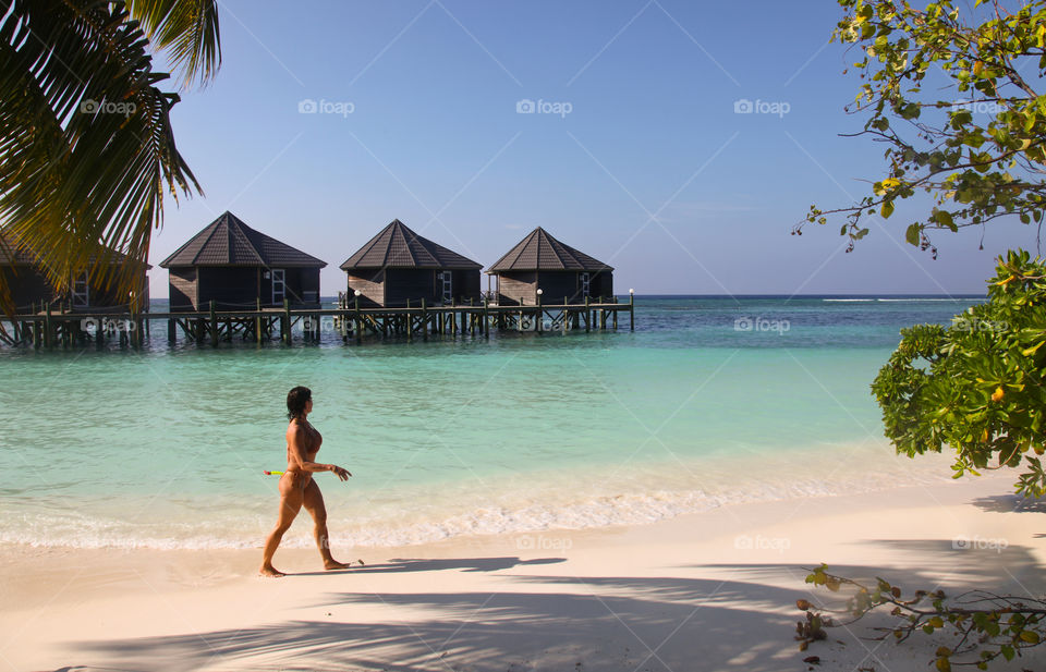 Woman walking on the beach. 