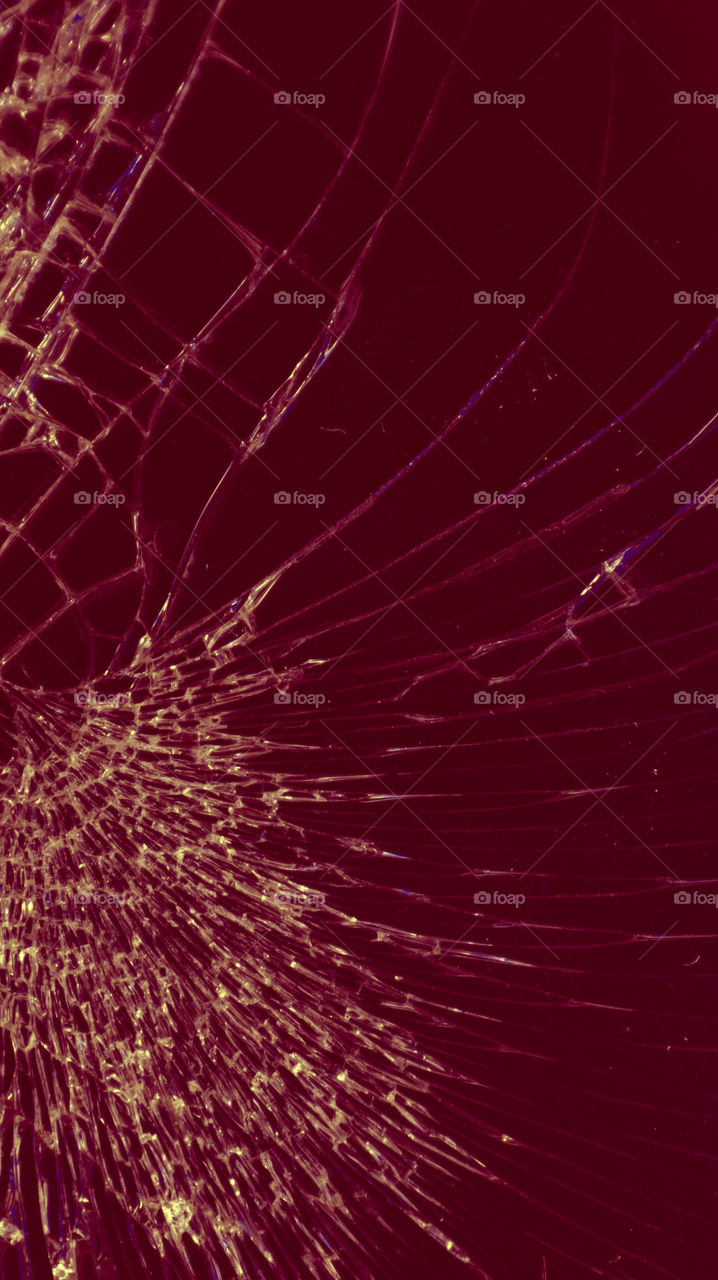 Multi-colored and bright broken smartphone screen close-up.