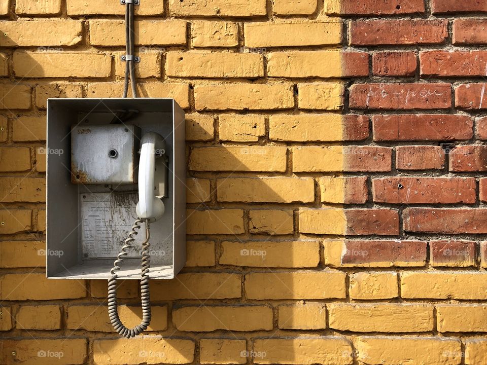 Phone on brick wall