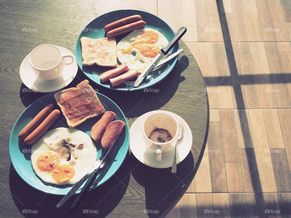 American breakfast on table at morning with shadow of sunshine