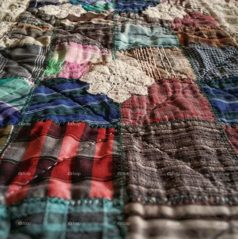 A table runner made of old shorts and lace close up in macro