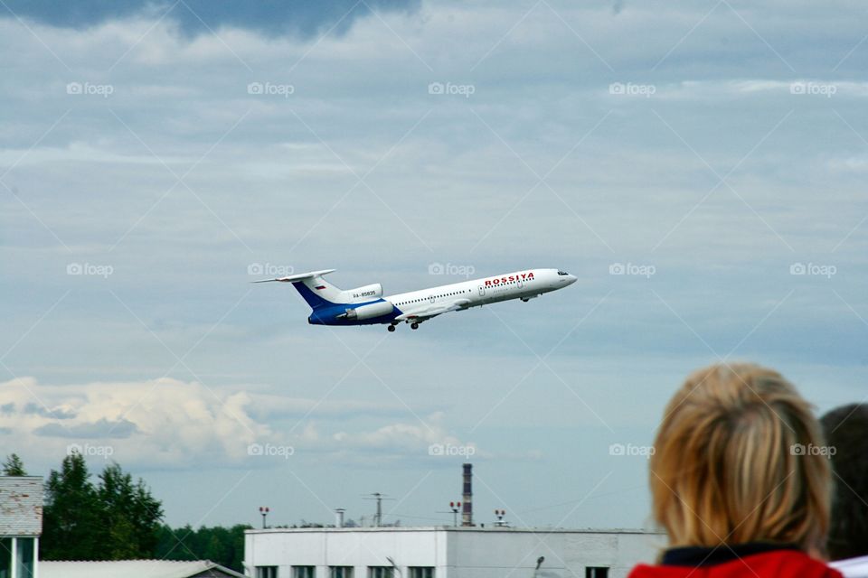 People looking at an airplane 