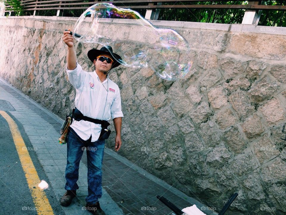 Man making giant bubbles
