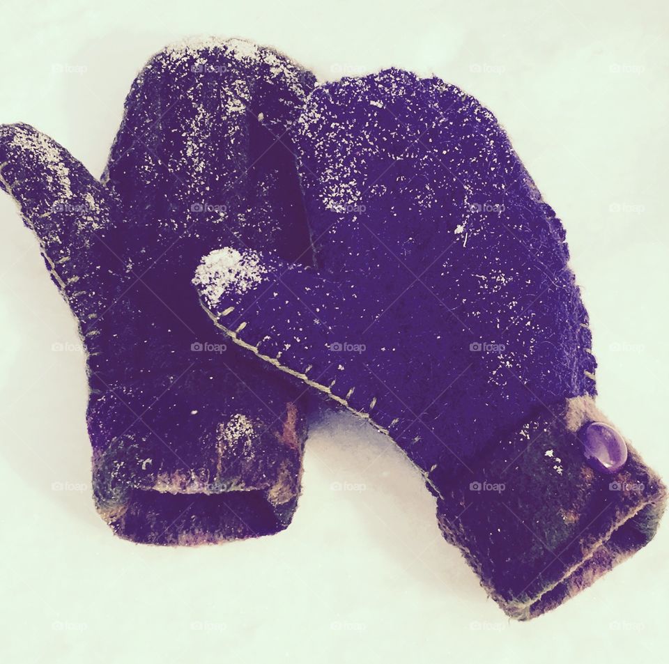 Purple mittens on snow