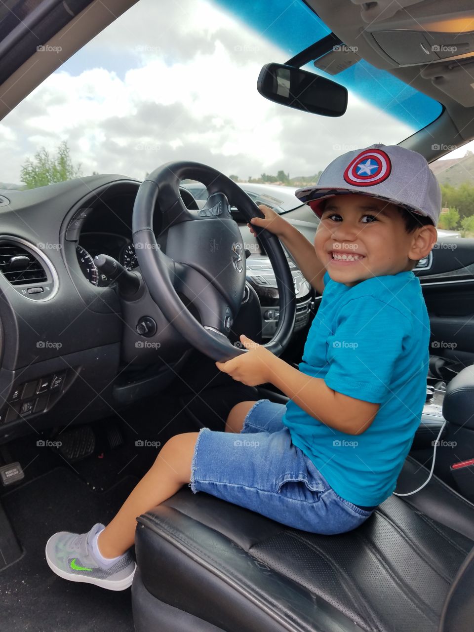 Happy boy driving the car