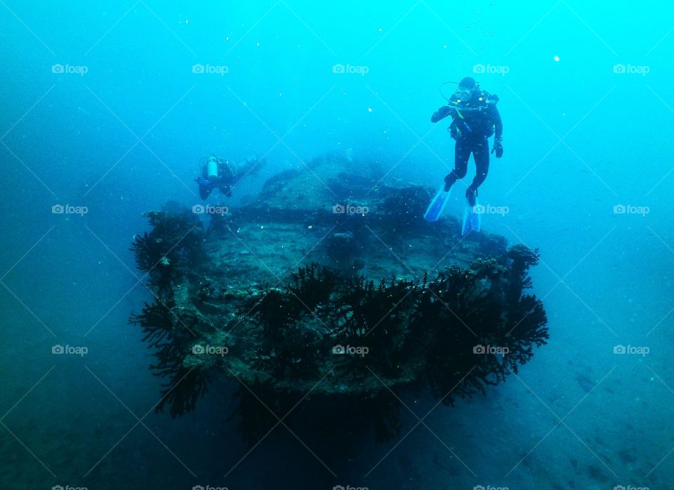 Diver over ship wreckage 