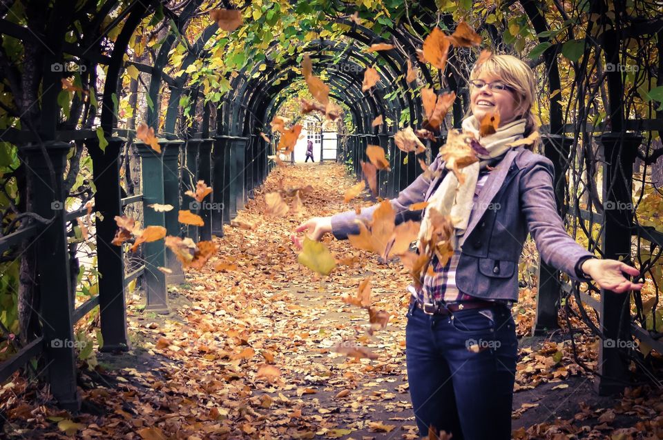 Happy woman with stretched arm during autumn season