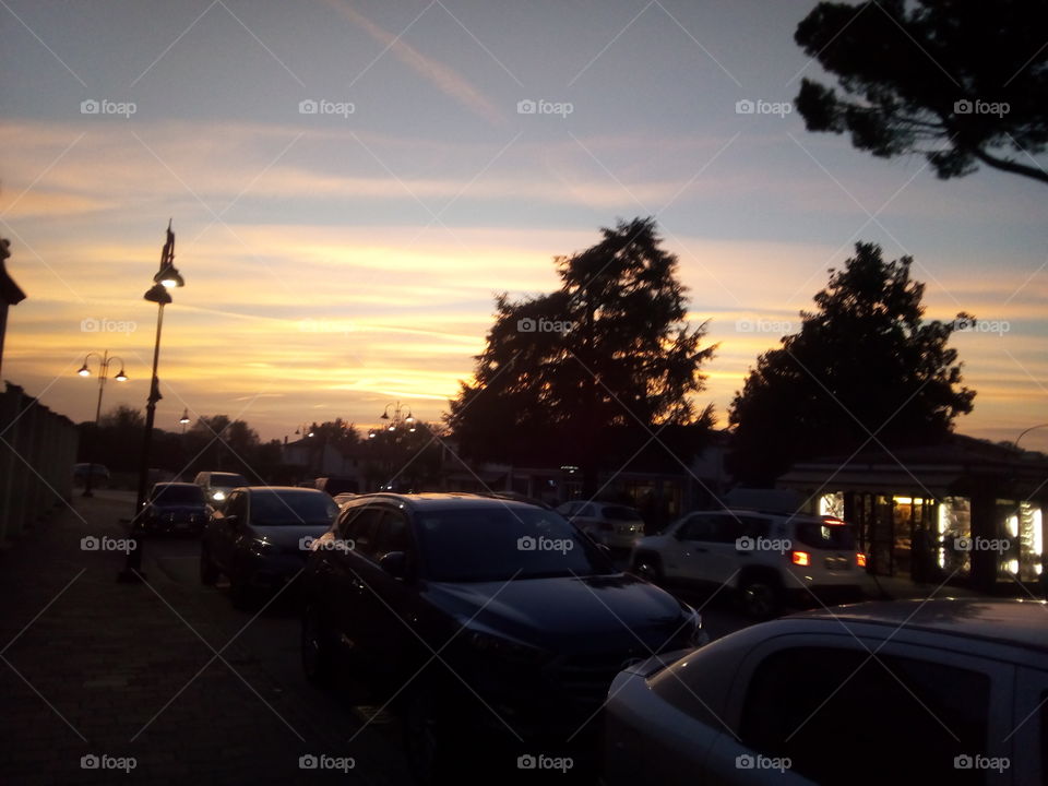Small, busy,country town during a sunset in a fresh evening