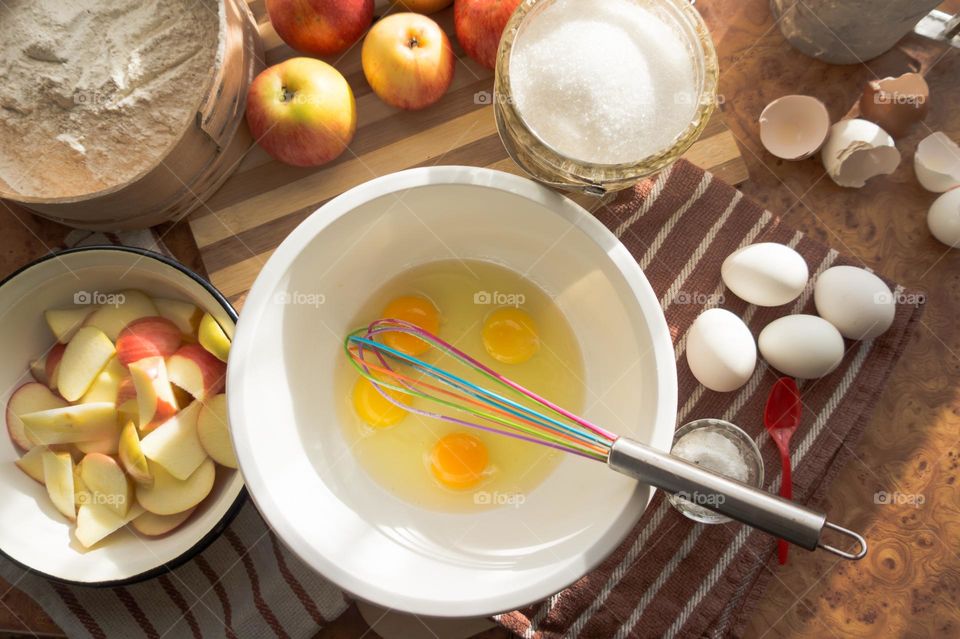 Making homemade puffed apple pie with eggs, sugar and flour.