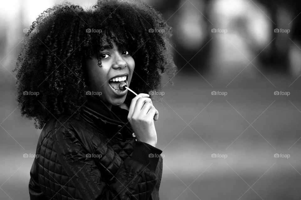 Black and White portrait of Africana girl waiting a Lollipop