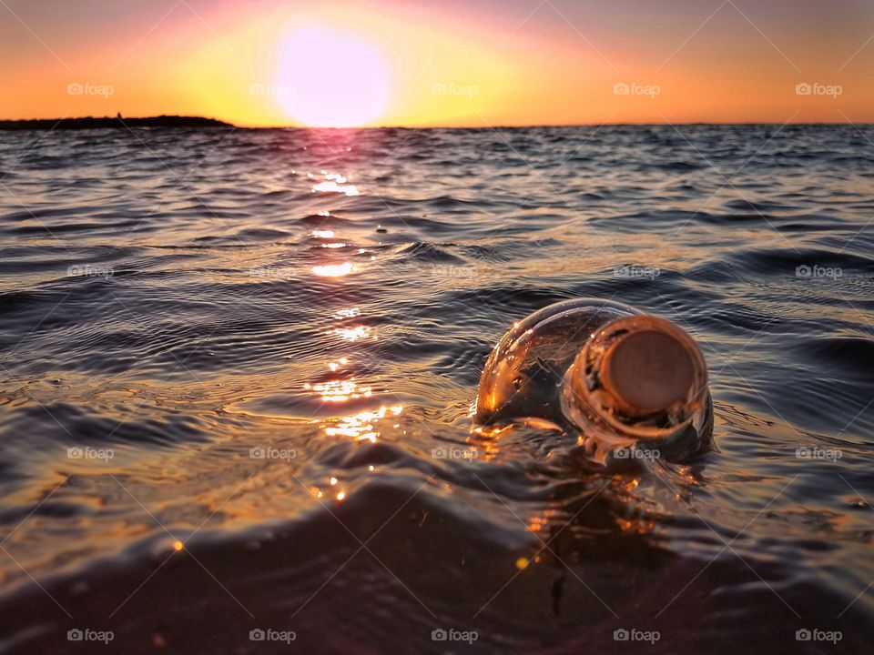 Message in a bottle ... floating away at sunset