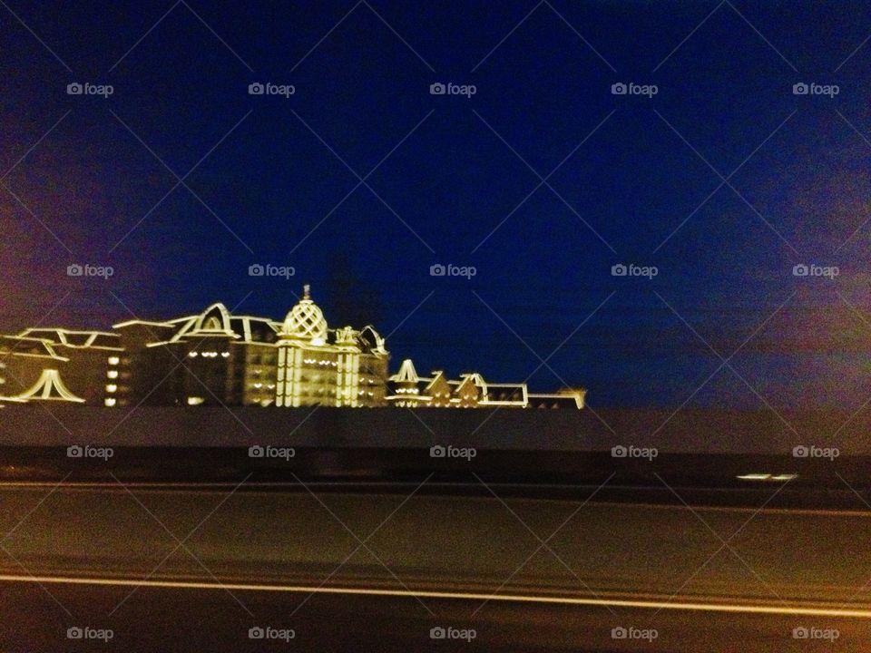 Illuminated building by the sea