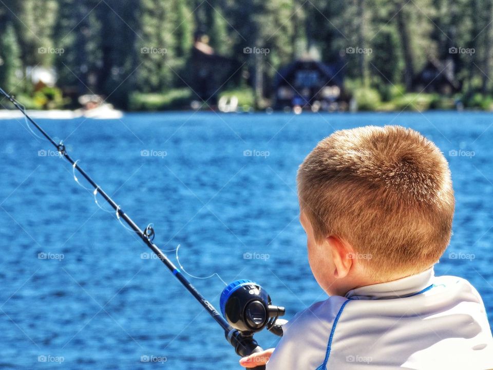 Boy Fishing In A Mountain Lake
